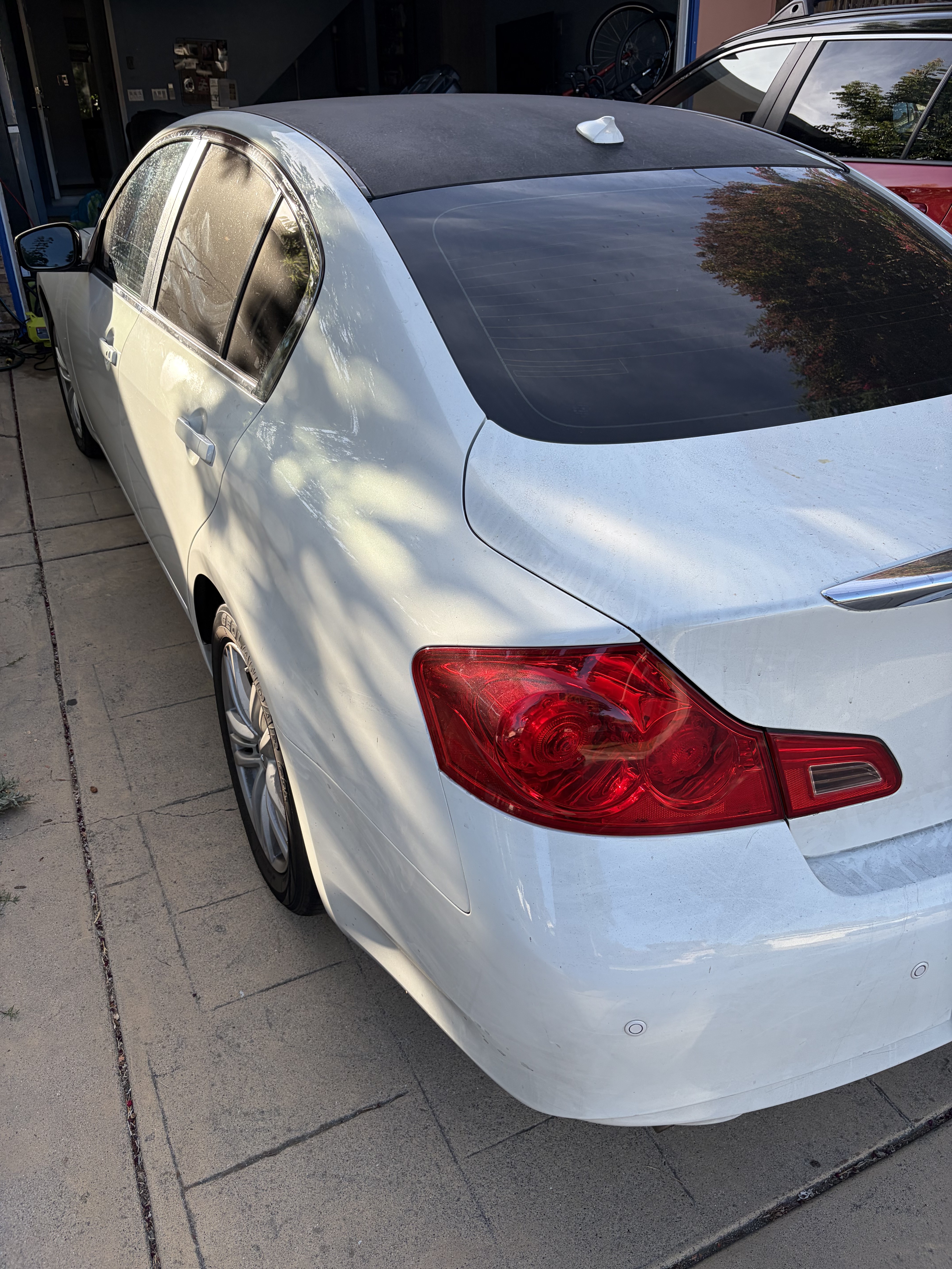 Heavily oxidized and swirled black car paint before detailing correction